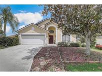 Charming house with a two-car garage and manicured landscaping at 122 Santana Pl, Davenport, FL 33897