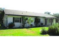 White brick ranch house with a covered porch at 3225 Oakland N Rd, Lakeland, FL 33801