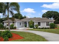 Single-Gathering home with a manicured lawn and circular driveway at 104 Van Fleet Ct, Auburndale, FL 33823