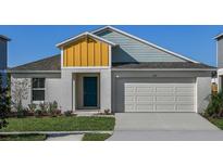 Craftsman style home with a teal door and two-toned siding at 1422 Sea Glass Rd, Haines City, FL 33844