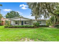 Ranch style home with white exterior and a covered front porch at 204 N Lake Reedy Blvd, Frostproof, FL 33843