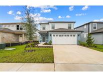 Two-story house with attached garage and landscaping at 285 Woodsage Pl, Lake Alfred, FL 33850