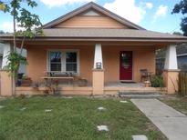 Charming bungalow with a red front door and covered porch at 819 Ariana St, Lakeland, FL 33803