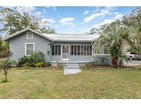 Gray house with a screened porch and landscaping at 323 Nw 25Th St, Ocala, FL 34475