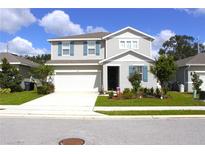 Two-story house with gray siding and blue shutters at 1125 Mattie Pointe Blvd, Auburndale, FL 33823