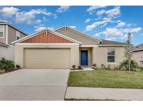 One-story home with attached garage and landscaped lawn at 1592 Ellesmere Ave, Haines City, FL 33844