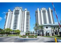 Twin highrise building exterior with fountain and landscaping at 13415 Blue Heron Beach Dr # 1101, Orlando, FL 32821
