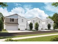 Three-story townhomes with attached garages and landscaping at 4325 Hillock Blvd, Haines City, FL 33844