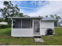 White cottage with screened porch at 1058 N Davis Ave, Lakeland, FL 33805
