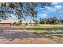 House exterior showcasing large lot and circular driveway at 2513 Lake Front Dr, Lake Wales, FL 33898