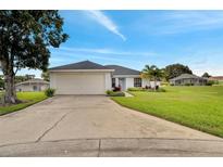 Single-story home with a two-car garage and landscaped yard at 254 Glasgow Ct, Davenport, FL 33897