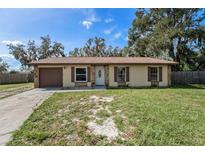 Single story house with brown garage door and stone accents at 3601 Deborah Dr # 3, Lakeland, FL 33810