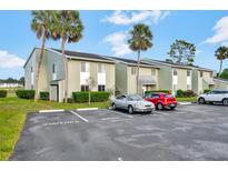 Exterior view of condo building with parking at 554 Fairways Cir # A, Ocala, FL 34472