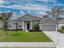 One-story home with gray siding and two-car garage at 232 Samantha Ave, Auburndale, FL 33823
