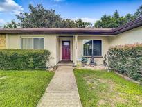 Front view of house with walkway and landscaping at 2002 Amesbury Dr, Auburndale, FL 33823