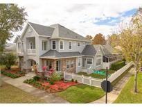Two-story house with gray siding, stone accents, and a landscaped yard at 3366 Cat Brier Trl, Harmony, FL 34773