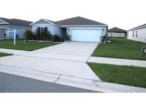 Single-story house with gray siding and white garage door at 148 Summerlin Loop, Haines City, FL 33844