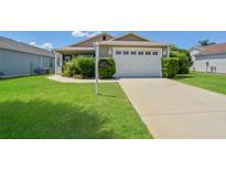 Well-maintained house with a two-car garage and spacious lawn at 2572 Berrington Loop, The Villages, FL 32162