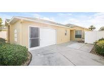 Single-car garage with driveway and landscaping at 2294 Trailwinds Ter, The Villages, FL 32162