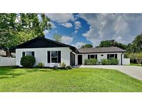Stunning ranch-style home with a well-manicured lawn at 1646 Center St, Deland, FL 32720