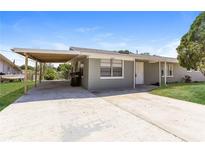 Gray house with carport and small yard at 1223 Avenue N, Haines City, FL 33844