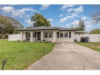 Newly renovated home with a landscaped yard and driveway at 132 James St, Auburndale, FL 33823