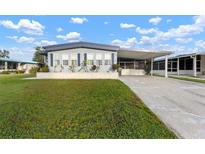 Single-wide manufactured home with carport and spacious lawn at 1610 Reynolds Rd # 159, Lakeland, FL 33801