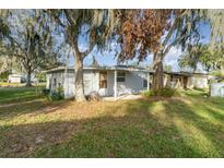 Ranch-style home with carport, mature trees, and spacious yard at 5342 Cooper Ln, Fort Meade, FL 33841