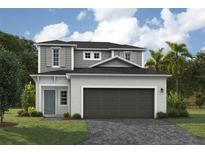 Two-story home with gray siding, dark garage door, and landscaping at 9587 Sw 62Nd Ct, Ocala, FL 34476