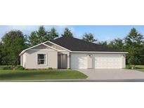 Two-story house with three car garage, light colored siding and landscaping at 2033 Lasso Loop, Eagle Lake, FL 33839