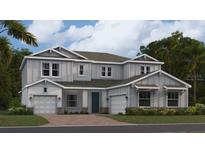 Two-story home with gray siding, two-car garage, and landscaping at 760 Terrapin Dr, Debary, FL 32713