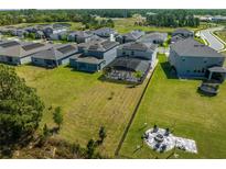 Aerial view of houses with solar panels and fenced backyards at 2613 Camden Park Loop, Davenport, FL 33837