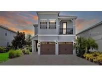 Two-story house with two-car garage and balcony at 7650 Fairfax Dr, Kissimmee, FL 34747