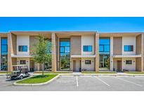 Modern townhome community with reserved parking and golf cart at 7482 Brooklyn Dr, Kissimmee, FL 34747