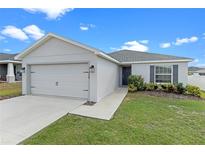 One-story home with a two-car garage and landscaped lawn at 524 Scenic Bluff Blvd, Lake Wales, FL 33853