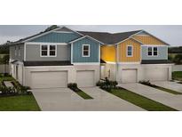 Three-unit townhome building with attached garages and landscaping at 3848 King Hill Dr, Haines City, FL 33844