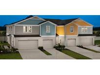 Three-unit townhome building with attached garages and attractive exterior finishes at 3864 King Hill Dr, Haines City, FL 33844