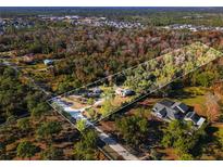 Aerial view of a house nestled within a sprawling wooded lot at 2468 Fawn Run, Oviedo, FL 32765