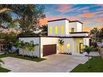 Modern two-story home with attached garage and landscaped front yard at 3225 Parkwood Ct, Kissimmee, FL 34744