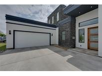 Modern home with attached two-car garage and stone facade at 3225 Parkwood Ct, Kissimmee, FL 34744