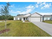 Newly built home with a two-car garage and landscaped lawn at 2162 Hadley Rd, Bartow, FL 33830