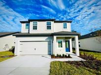 Two-story house with a two-car garage and landscaped yard at 13465 Leaping Water Way, Astatula, FL 34705