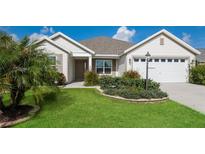 Charming single-story home with a landscaped front yard and two-car garage at 5638 Cedar Waxwing Dr, The Villages, FL 32163