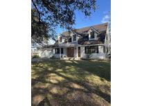 Two-story house with a large yard, three-car garage, and brick accents at 6611 Hereford Dr, Lakeland, FL 33810