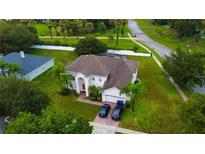 Two-story house with large backyard, two-car garage, and paved driveway at 239 Beacon Pointe Dr, Ocoee, FL 34761