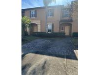 Inviting townhome exterior with brick paver driveway at 3928 Calabria Ave, Davenport, FL 33897