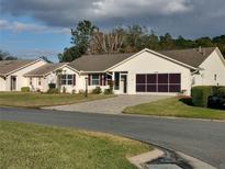 Charming single-story home with attached garage and landscaped front yard at 26608 Racquet Cir, Leesburg, FL 34748