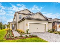 Two-story home with a two-car garage and landscaped front yard at 7752 Somersworth Dr, Kissimmee, FL 34747