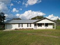 Ranch style home with metal roof, carport and spacious yard at 4915 Mount Pleasant Rd, Groveland, FL 34736
