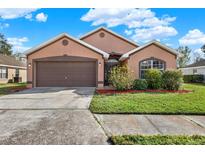 Beautiful one-story home with a two-car garage and well-manicured lawn at 1771 Turtle Rock Dr, Lakeland, FL 33803
